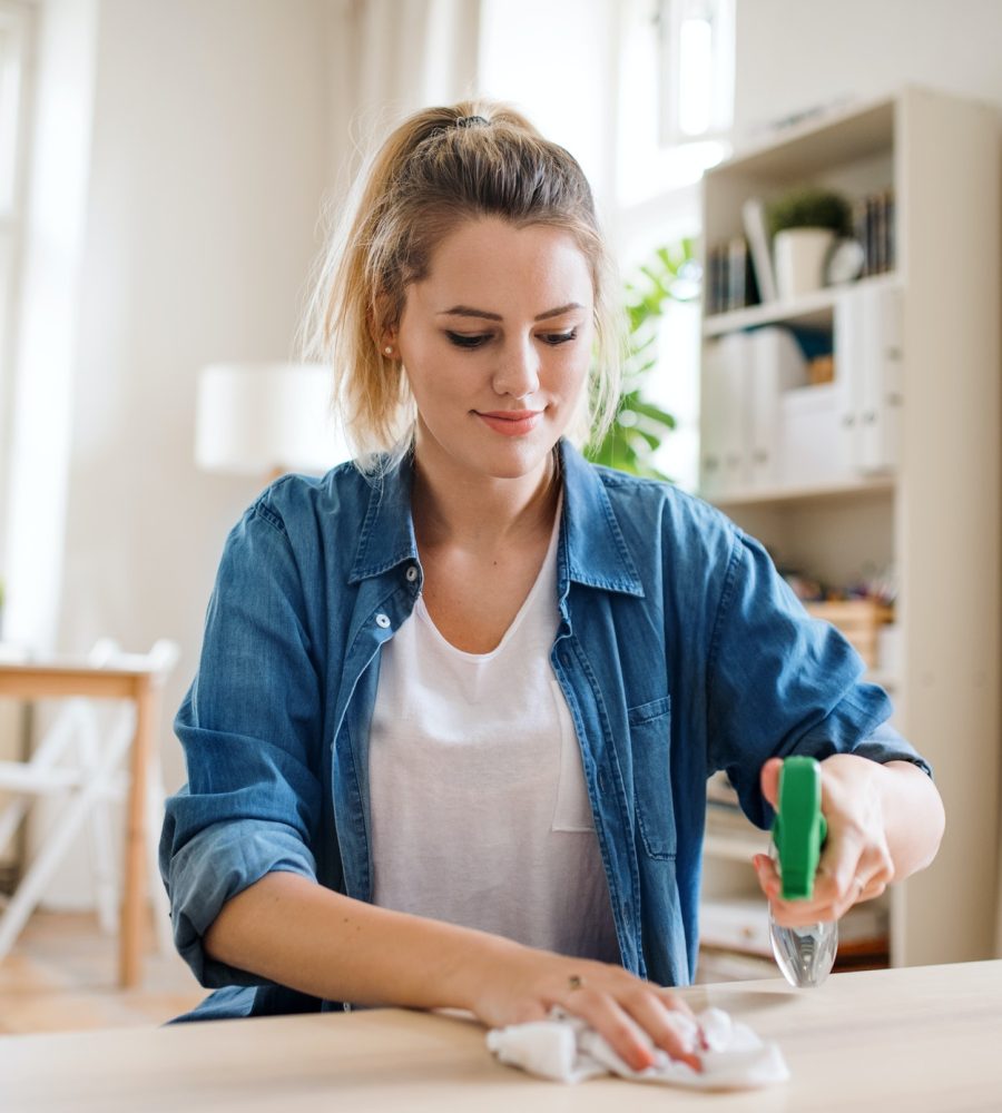 young-woman-indoors-at-home-cleaning-table-.jpg